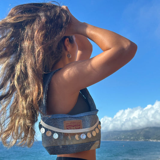 person by the ocean wearing denim bag